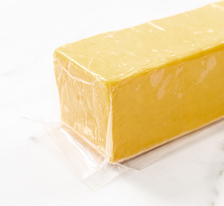 Cheese block showing off film packaging.