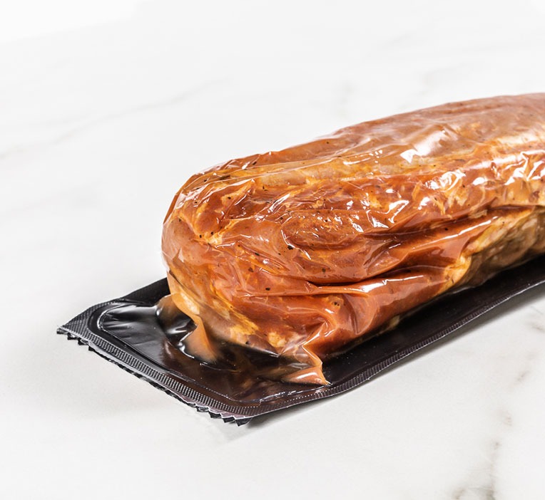 Pork tenderloin showing off film packaging.
